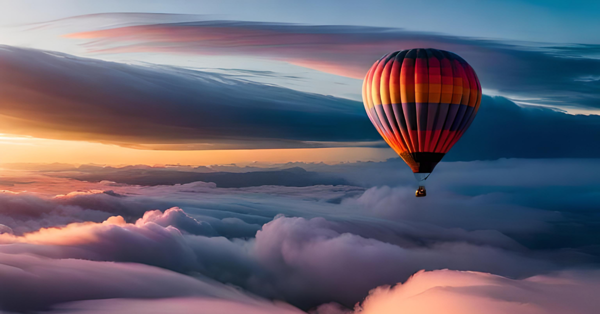 A hot air balloon flying over a sea of clouds. Stunning collection of white clouds from above with sunlight over the horizon